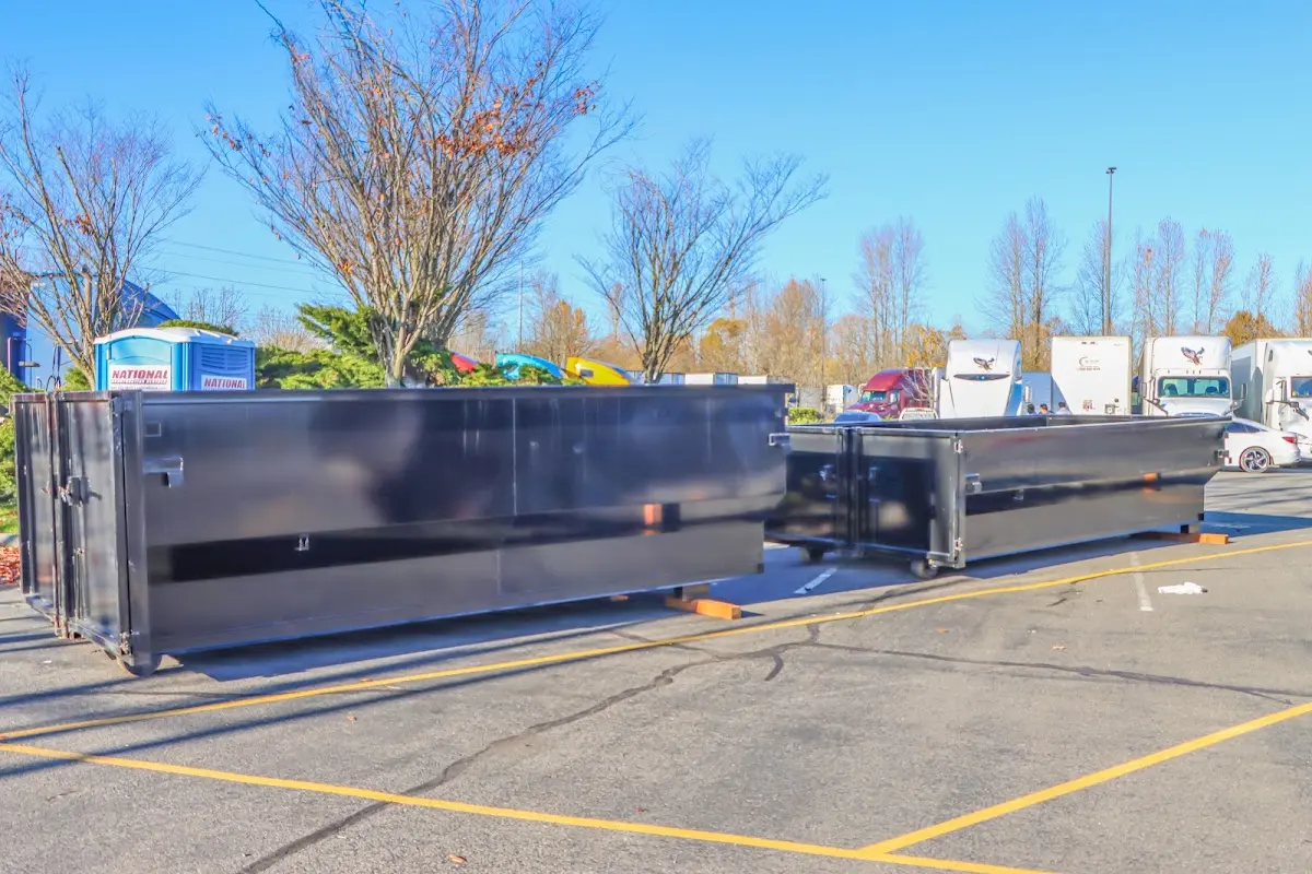 Professional dumpster rental service with roll-off container on residential driveway in San Rafael